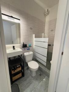 a bathroom with a toilet and a sink and a mirror at SIDI apartments in Polychrono