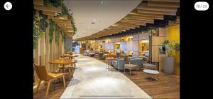 a lobby with tables and chairs in a building at Hotel Nacional, Rio de Janeiro, Suíte Luxo com Banheira in Rio de Janeiro