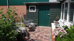 RabenholzSabricke的房屋前设有带桌椅的天井。