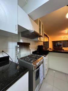 a kitchen with a stove top oven in a kitchen at Style and location in Miraflores by AG in Lima