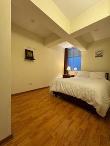 a bedroom with a large bed and a window at Style and location in Miraflores by AG in Lima