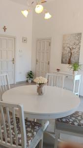 a white table and chairs in a dining room at Villa Annarè in Martina Franca