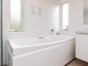 a white bathroom with a sink and a mirror at 4 star holiday home in Brovst in Brovst +31 photos