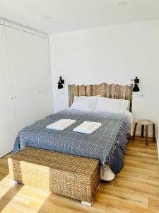 a bedroom with a bed with two towels on it at Maison de Sable - Possanco in Comporta +29 photos