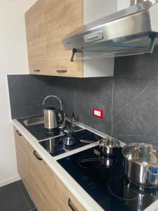 a kitchen with pots and pans on a stove at Lussari Style Apartments in Tarvisio