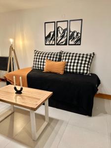 a living room with a couch and a table at Los Basaltos departamentos in Caviahue