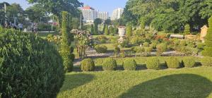 a garden with bushes and flowers in a park at Sea View Slavia in Międzyzdroje