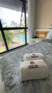 Una cama o camas en una habitación de Porto de galinhas flat marulhos resort