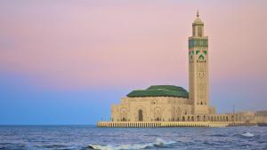 a building with a clock tower in the middle of the ocean at Herb studio in Casablanca (800 m from Casavoyageurs station) in Casablanca
