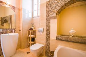 a bathroom with a white toilet and a sink at Thea in Symi