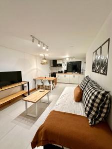 a living room with a couch and a table in it at Los Basaltos departamentos in Caviahue