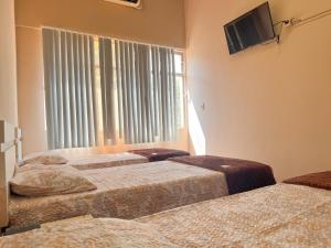 Postel nebo postele na pokoji v ubytování Hotel Familiar en Centro de Ciudad del Este