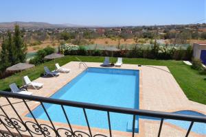 a view of a swimming pool from a balcony at Dar El Yakout in Essaouira