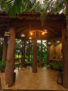 a pavilion with trees and a patio with lights at Casa das Palmeiras Pousada in Treviso