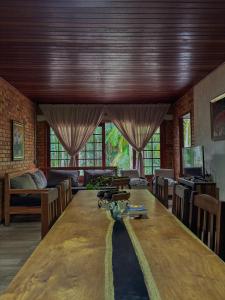 a room with a large wooden table in a room at Casa das Palmeiras Pousada in Treviso