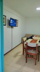a room with a table and a tv on a wall at Departamento Céntrico con Balcón a la calle in Mar del Plata