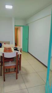 a room with a table and chairs and a green door at Departamento Céntrico con Balcón a la calle in Mar del Plata +4 photos