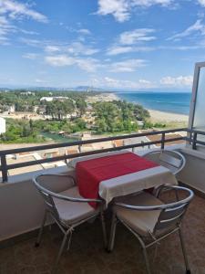 a table and chairs on a balcony with a view of the ocean at Aparments Plaza in Velika Plaža