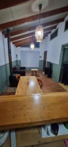 a large room with a wooden table and chairs at Yenú Aiken in Coihaique