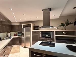 a kitchen with stainless steel appliances and a counter top at Mytilene Luxury Villa Garden Level in Mytilene