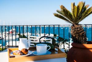 a tray of food on a table with a view of the ocean at L'Approdo delle Sirene in Syracuse