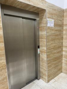 a metal elevator in a building with a sign on it at city center hideaway in Durrës