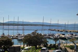 a group of boats docked at a marina at Apartments by the sea nska, Krk - 24705 in Malinska +5 photos