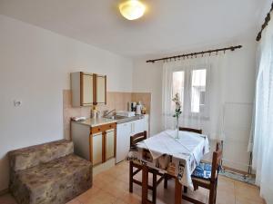 a kitchen with a table and a sink at Apartment Nada in Rab