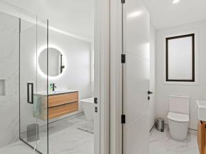 a bathroom with a toilet and a sink and a mirror at Entire Hawea Holiday Home near Wanaka 2-10 guests in Lake Hawea +20 photos