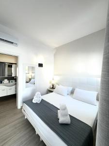 Ένα ή περισσότερα κρεβάτια σε δωμάτιο στο AQUARAMA Rooms & Apartments