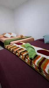 two beds sitting next to each other in a room at Apartamento central - Villa Xiomara in Santa Rosa de Cabal