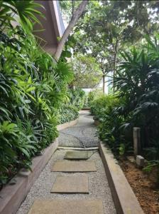 a garden with a walkway with rocks and plants at Luxury 22 Home 6Pax Old Klang Road Mid Valley KL Centre in Kuala Lumpur