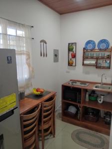 a kitchen with a sink and a counter with chairs at Sunzal Refugio Perfecto-3 in El Sunzal