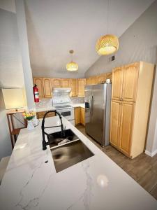 a kitchen with wooden cabinets and stainless steel appliances at Charming 3-bedroom house in delightful Lewisville with AC, WiFi in Lewisville