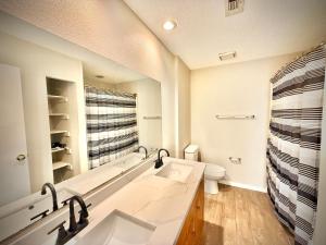 a bathroom with a sink and a toilet at Charming 3-bedroom house in delightful Lewisville with AC, WiFi in Lewisville