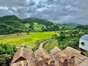 a view from a resort with mountains in the background at บ้านไม่ไผ่บ้านเวร-BambooHouse Banwen in Ban Khun Nam Nan