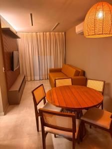 a living room with a table and a couch at Encanto Moanara in Luis Correia