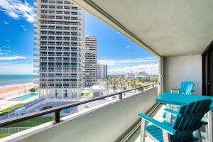 a balcony with two chairs and a view of the ocean at Aliki Atrium Beachfront Condo in Ormond Beach