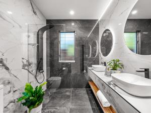 a bathroom with a sink and a shower at Coastal Dream BeachFront Oasis in Newcastle