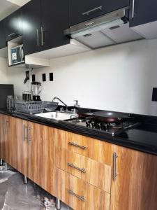 a kitchen with a sink and a stove at Departamento en Querétaro in Querétaro