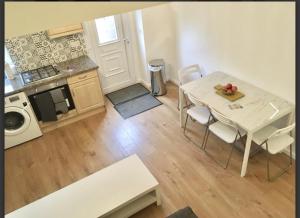 a small kitchen with a table and chairs in a room at Living Stone 1 Room in Kent
