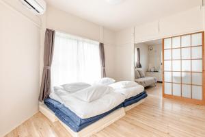 Postel nebo postele na pokoji v ubytování tkm北小岩1丁目101
