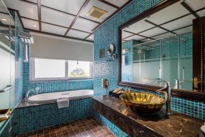 a bathroom with a large mirror and a sink at Solis Hotel in Hanoi