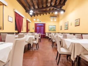 a dining room with white tables and chairs at Holiday Home in Carlentini with Swimming Pool,Garden,Terrace in Agnone Bagni