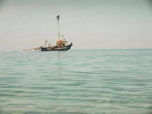 a boat in the middle of the water at Holiday Home in Carlentini with Swimming Pool,Garden,Terrace in Agnone Bagni