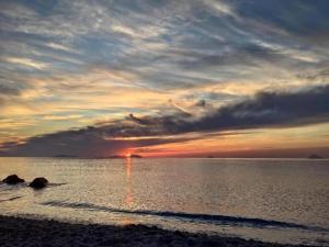 a sunset on the beach with the sun setting at Holiday Home in Carlentini with Swimming Pool,Garden,Terrace in Agnone Bagni