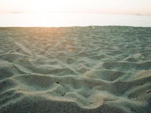 a sandy beach with footprints in the sand at Holiday Home in Carlentini with Swimming Pool,Garden,Terrace in Agnone Bagni