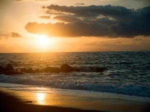 a sunset on the beach with the ocean at Holiday Home in Carlentini with Swimming Pool,Garden,Terrace in Agnone Bagni