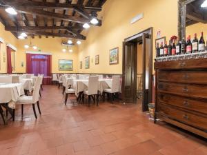 a dining room with tables and chairs and wine bottles at Holiday Home in Carlentini with Swimming Pool,Garden,Terrace in Agnone Bagni