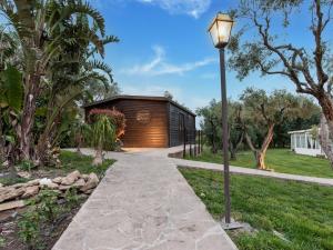 a house with a light pole next to a walkway at Holiday Home in Carlentini with Swimming Pool,Garden,Terrace in Agnone Bagni